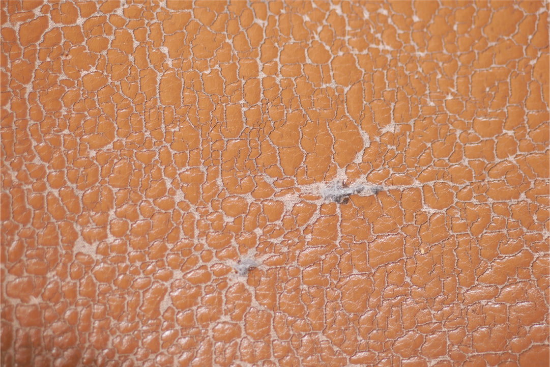 Close up of textured orange material with cracks