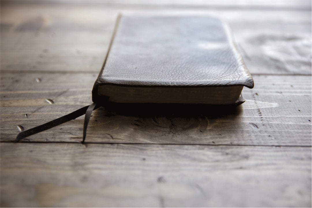 Leather bound book on a wooden surface