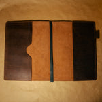 Dark Brown full grain leather notebook cover with leather bookmark on a brown background
