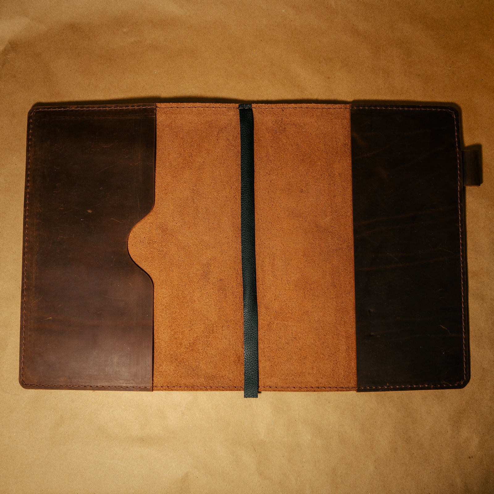 Dark Brown full grain leather notebook cover with leather bookmark on a brown background