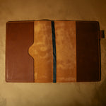 Empty whiskey orange leather journal cover on a beige background