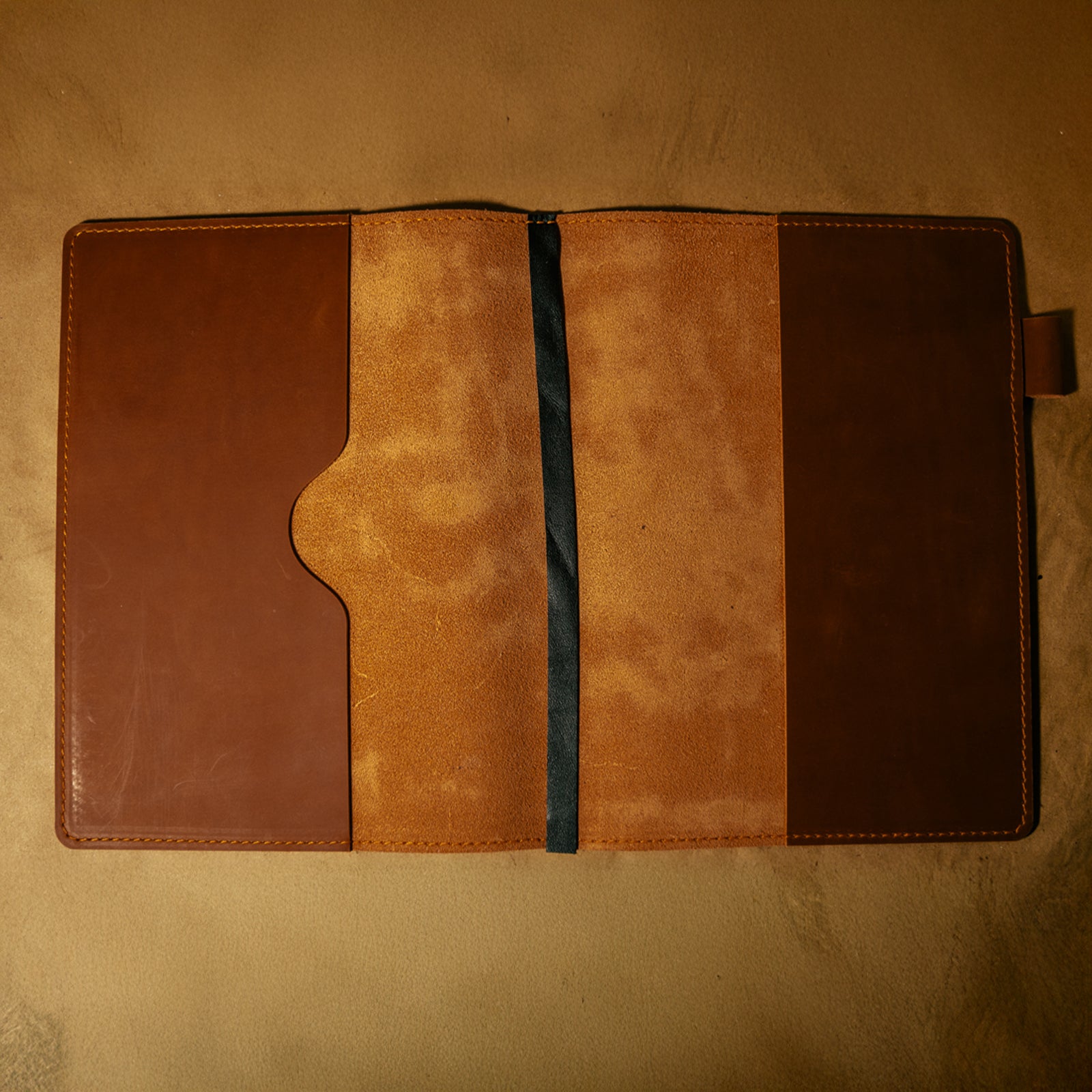 Empty whiskey orange leather journal cover on a beige background