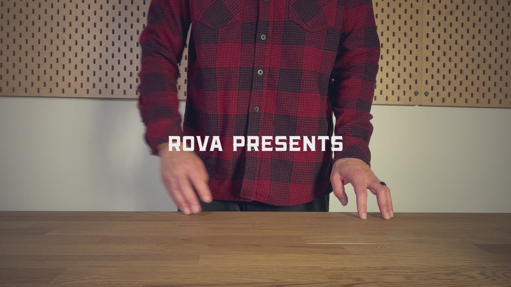 Unboxing video of the ROVA full grain leather journal cover on a wooden desk wearing a plaid shirt.